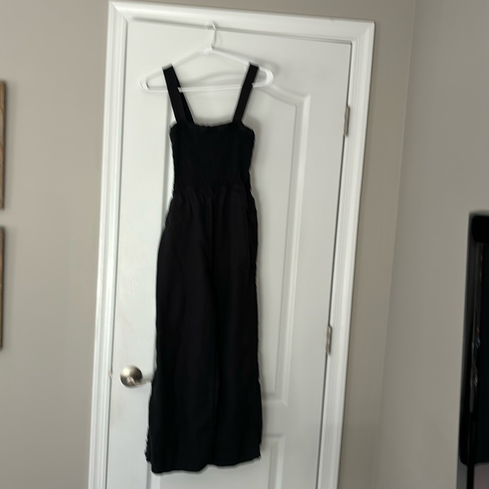 J Crew black linen jumpsuit with smocked top, pockets and wide legs.